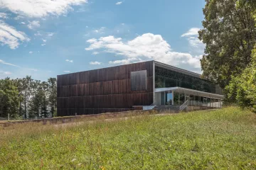 The Sport-Toto building viewed from the outside. It has a wood-panels outside wall